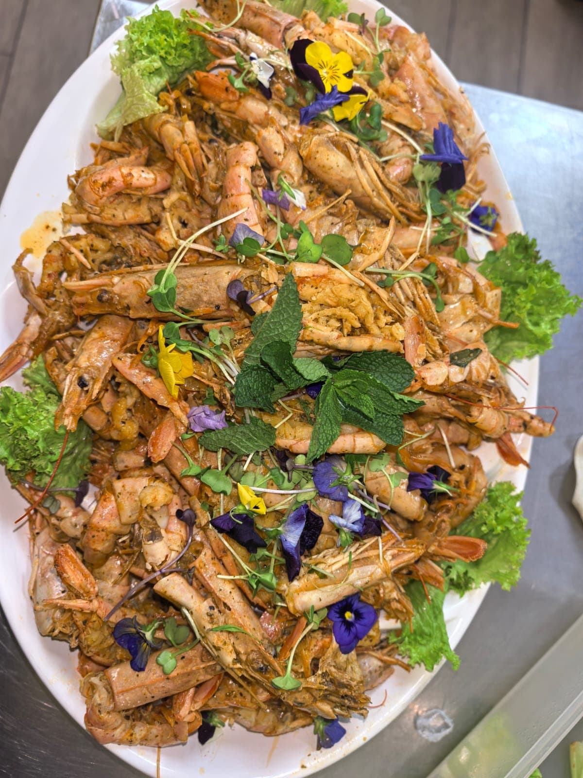 Grilled prawn platter finished with fresh herbs at Fusion Flame